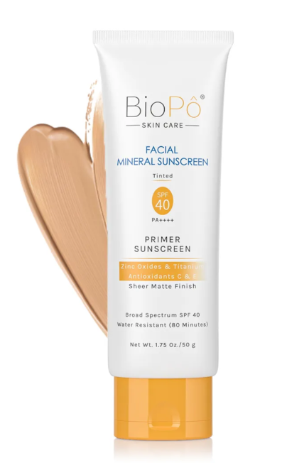 white bottle of sunscreen primer with orange lid