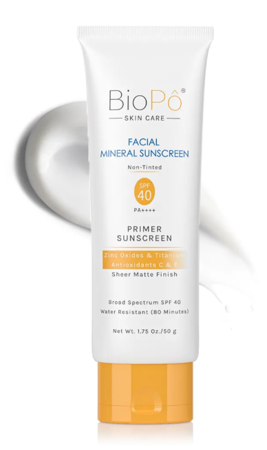 white bottle of sunscreen primer with orange lid