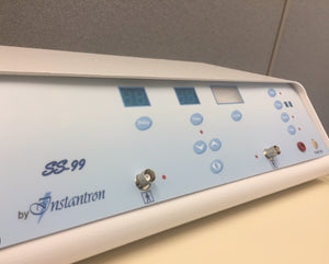 "Instantronics SS-99 base model electrolysis machine featuring a sleek design, with digital and analog meters for precise control. The unit includes membrane switches, a tone signal for skin contact, and an optional footswitch for operation. Compact and professional-grade, for thermolysis treatments."