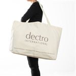 "Person in all black holding a large resuable cotton Dectro bag"