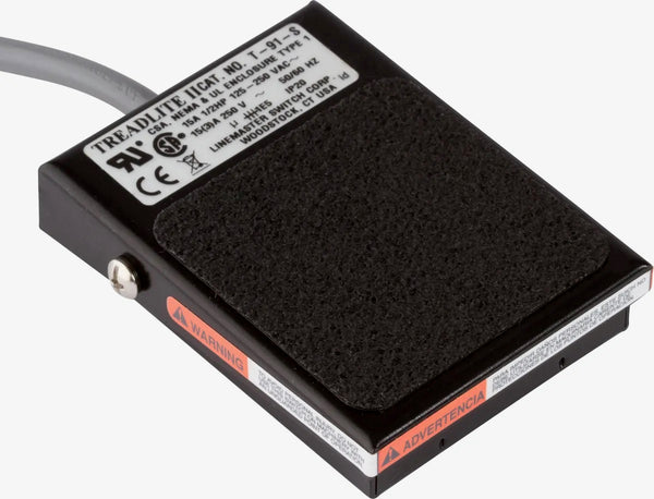 "A flat, black electrolysis foot pedal with a non-skid base and foot pad, designed for Hinkel electrolysis machines. The pedal measures 3.5” x 2.5” and includes a round, 3-prong plug, offering easy and effective foot activation."