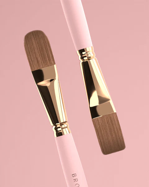 "Brow Daddy Framework Master Brush, available in 2 options, for precise application in brow makeup and microblading, displayed on a clean, pink background , brush aside a box"