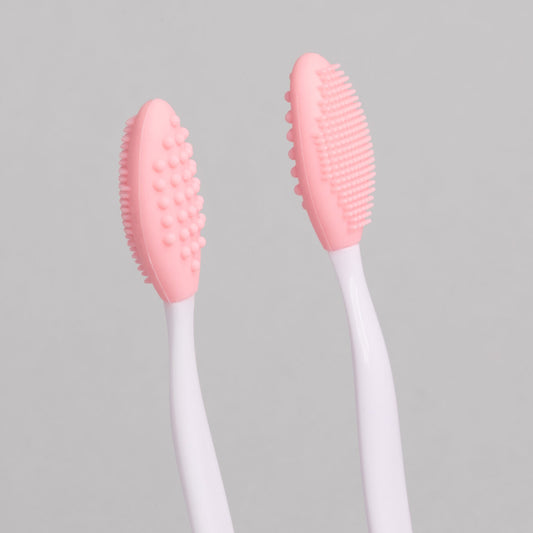 "Exfoliating Eyebrow Brush - A & E Beauty Supplies. pink silicone brush on a white stick"