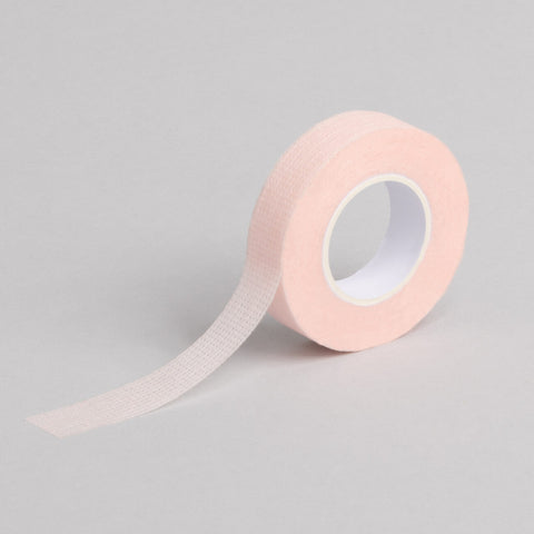 "A roll of pink coloured Bee Pampered Lash Tape, ideal for securing and protecting lashes during extensions or treatments, with a sleek and professional design, displayed on a clean, neutral background."