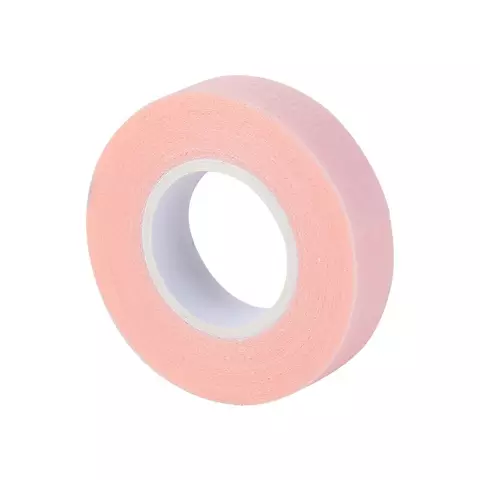 "A roll of pink coloured Bee Pampered Lash Tape, ideal for securing and protecting lashes during extensions or treatments, with a sleek and professional design, displayed on a clean, neutral background."