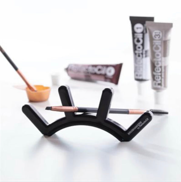 "RefectoCil Brushanizer by A & E Beauty Supplies, a hygienic and decorative tool organizer for brow and lash professionals. A black eyebrow shaped holder for brushes."
