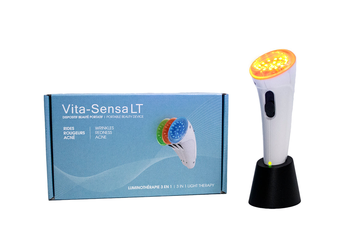 "The Vitali-T Vita-Sensa LT New Generation facial stimulator features a white handle with an orange head and a blue box. It is designed for light therapy treatments using three color options: red, blue, and green for skin rejuvenation, acne, and redness reduction."